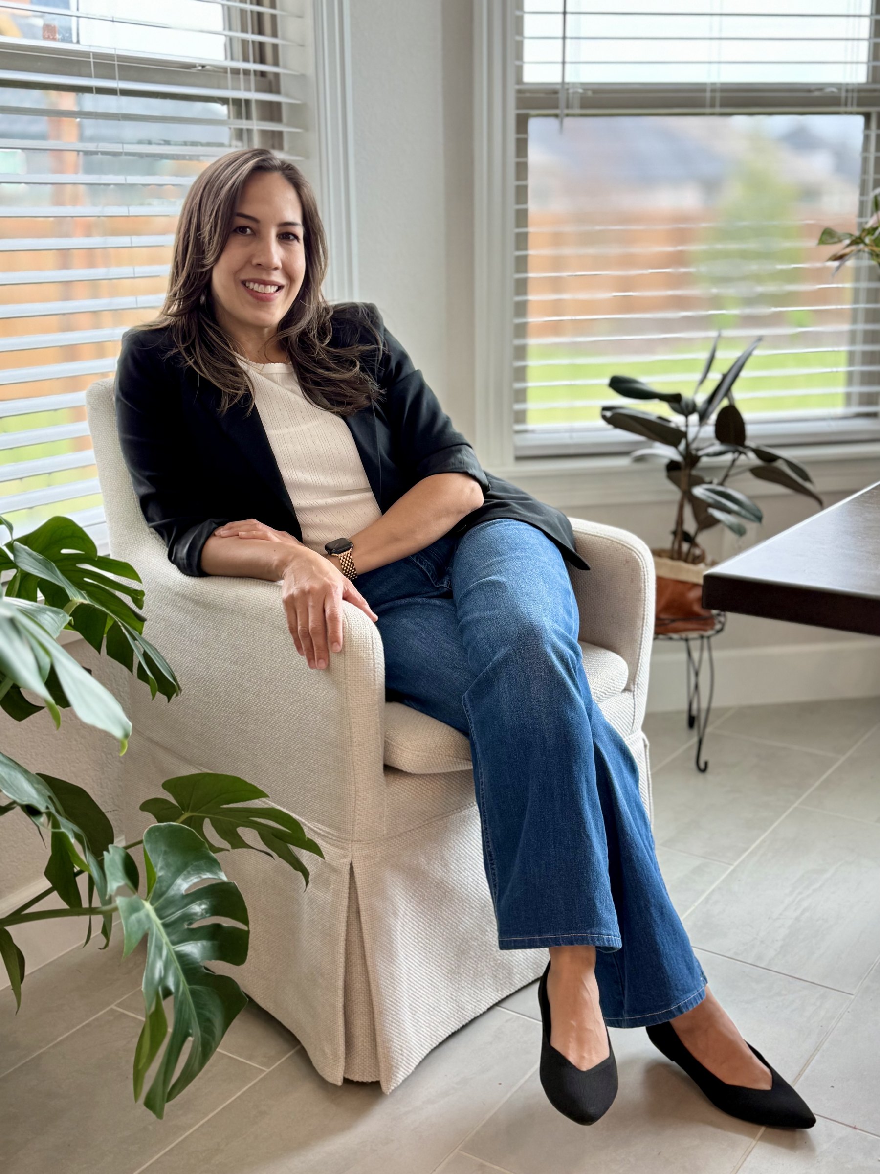 Amber Michelle seated in her home, ready to connect