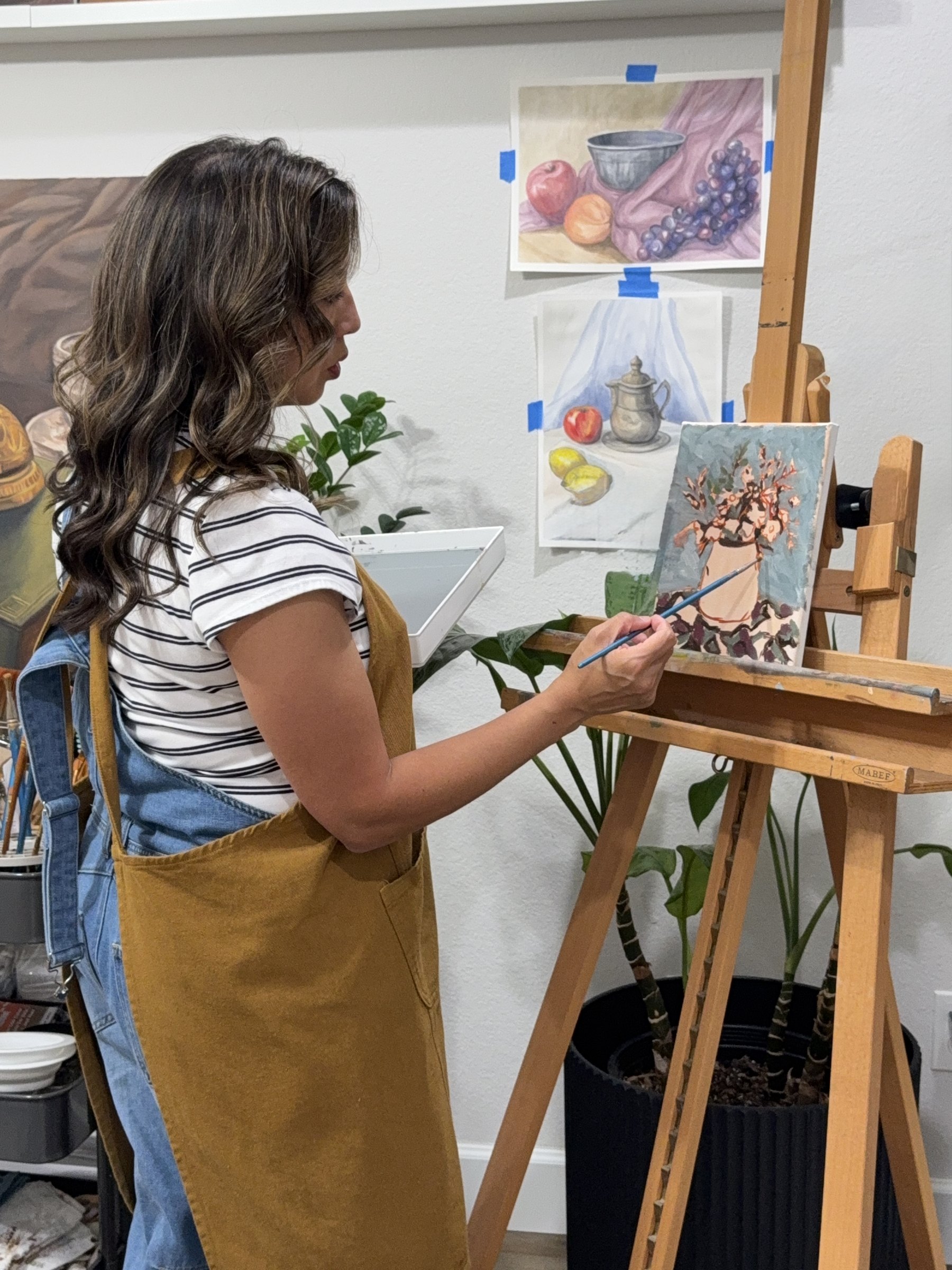 Amber Michelle painting at her easel